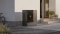 The image shows the floor-mounted Vitocal 200-A ie outdoor unit to the left of the front door of a modern-looking single-family home. 